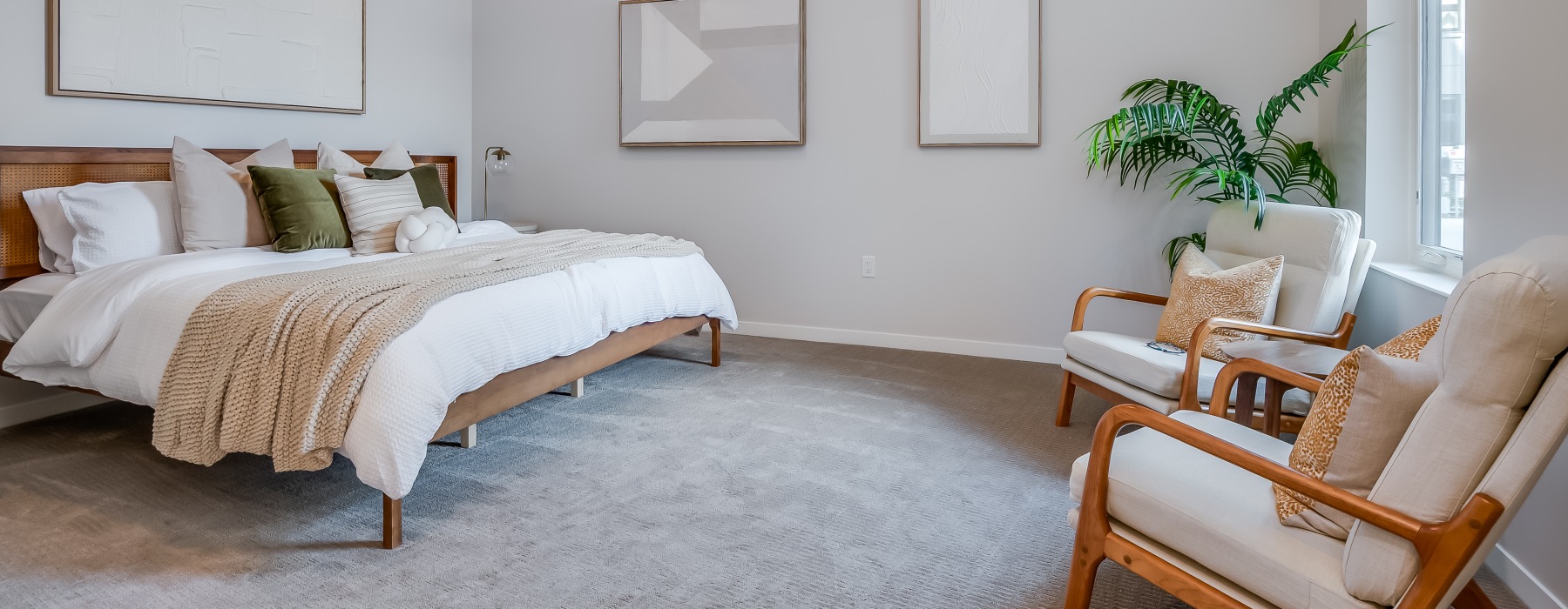 a bedroom with a bed and two chairs