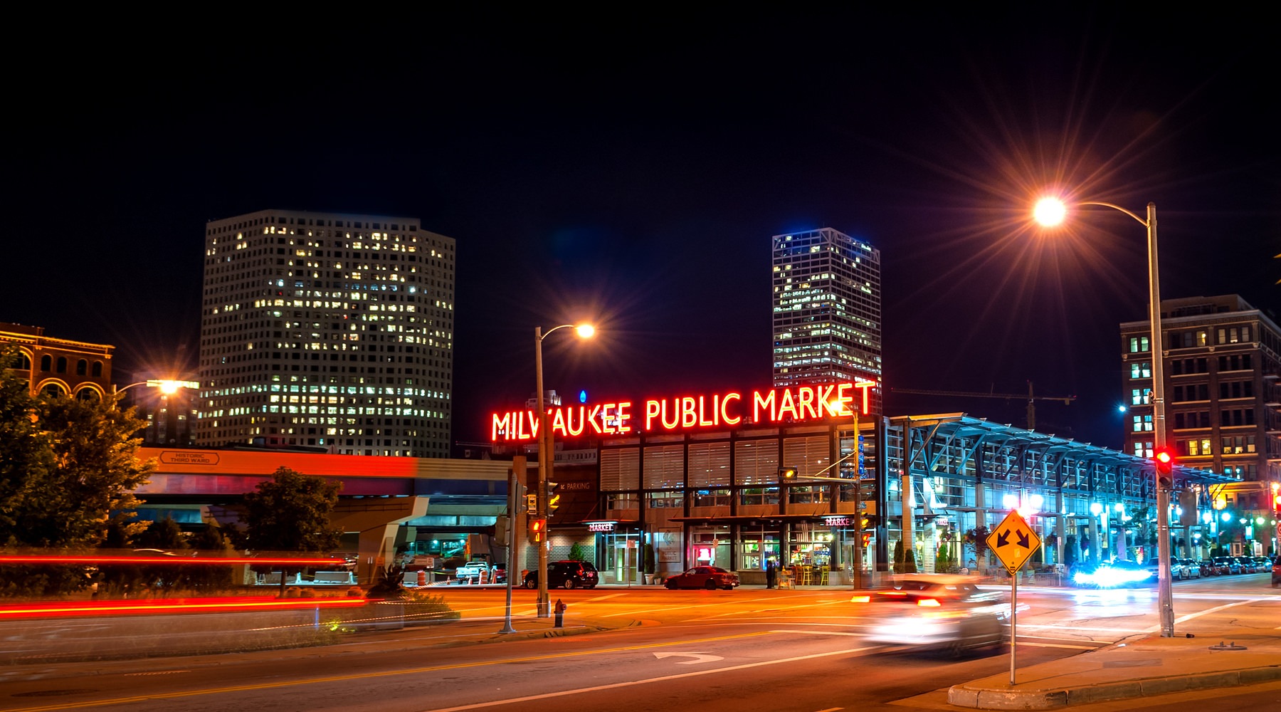 At the center of it all Night photo of a market and a street