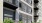 a building with balconies and plants in front of it